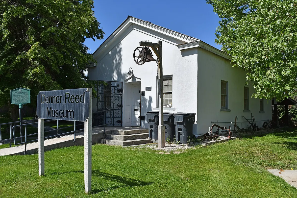 The stone Donner-Reed Museum building in downtown Grantsville, Utah, under a clear sky