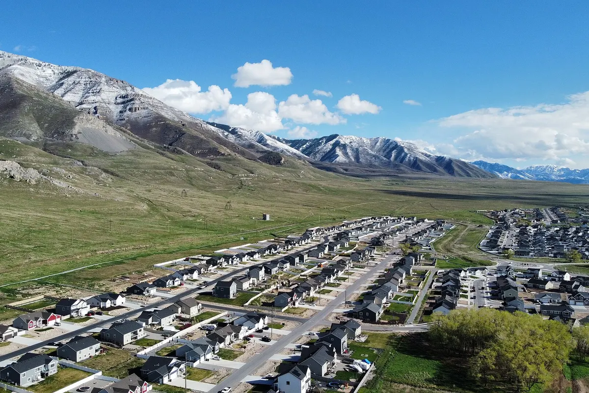 Aerial view of homes in Lake Point, Utah, with the snow-covered Oquirrh Mountains behind