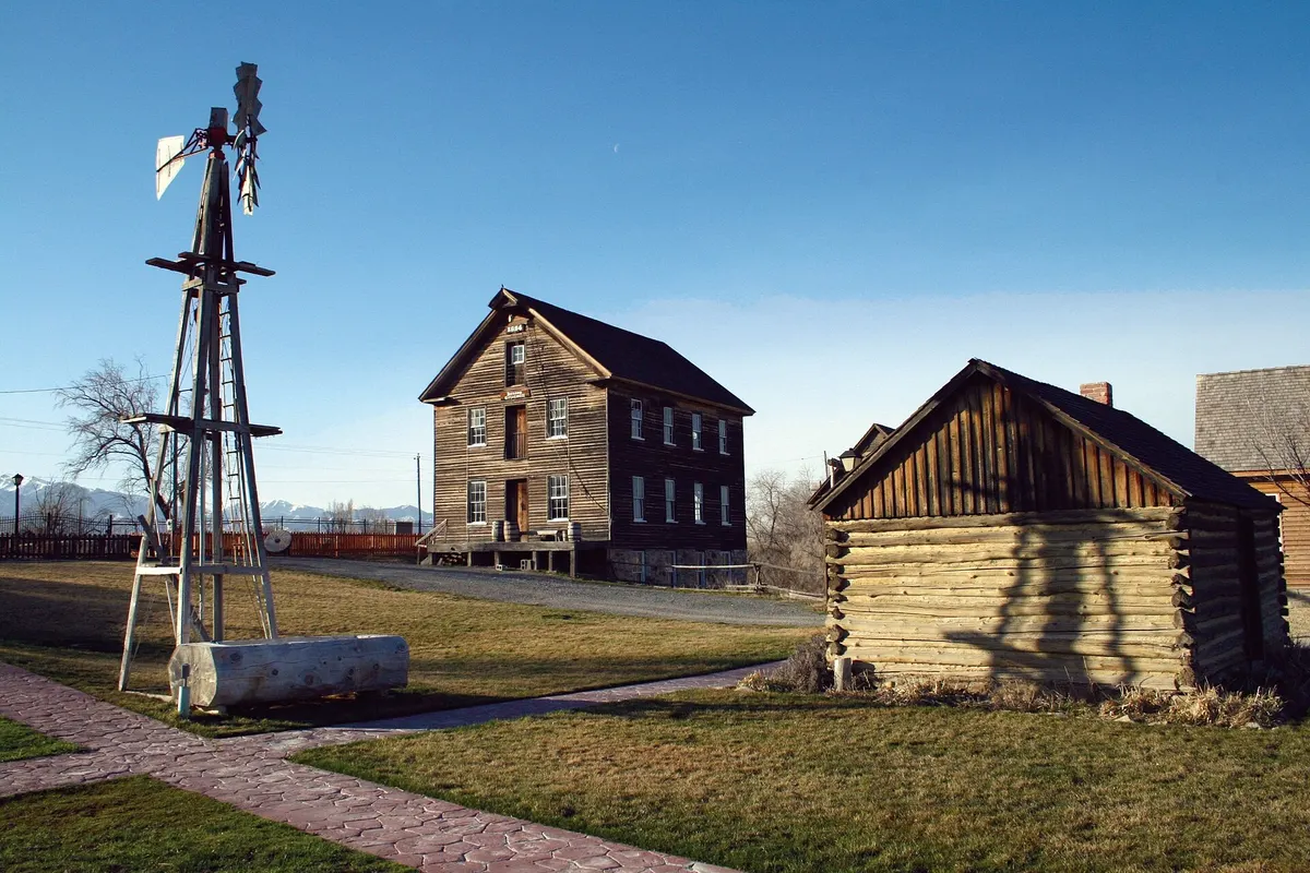 The historic Benson Grist Mill, a wooden mill building with a water wheel, in Stansbury Park, Utah